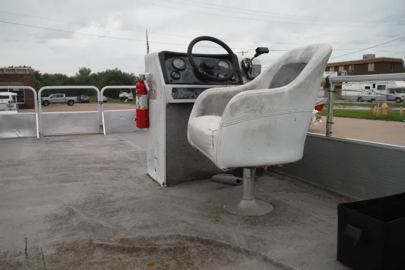 Slide: The Image of 1989 Sea Nymph SS200 Suncruiser boat interior with steering console and captain's chair. - 10