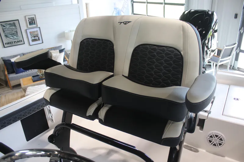 Slide: The Image of 2026 Tidewater 2300 Carolina Bay boat seats with black and white upholstery in a modern interior. - 14
