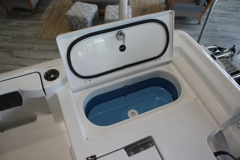 Slide: The Image of 2026 Tidewater 2300 Carolina Bay boat with open storage compartment, showcasing interior design. - 16