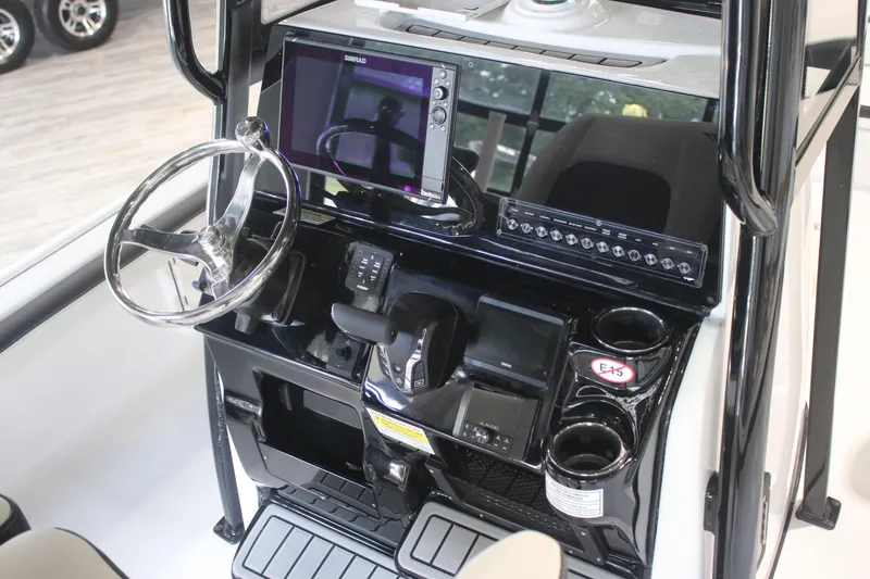 Slide: The Image of 2026 Tidewater 2300 Carolina Bay boat console with steering wheel and electronic controls. - 6