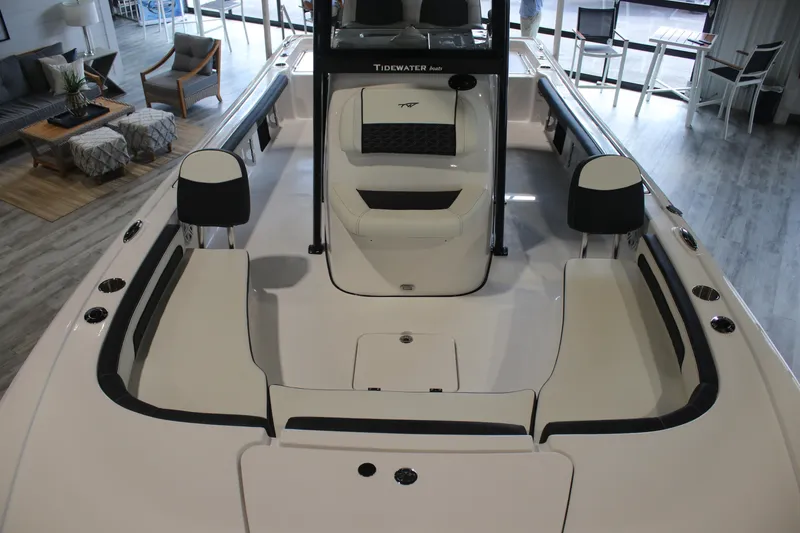 Slide: The Image of 2026 Tidewater 2300 Carolina Bay boat interior with seating and console in showroom. - 8