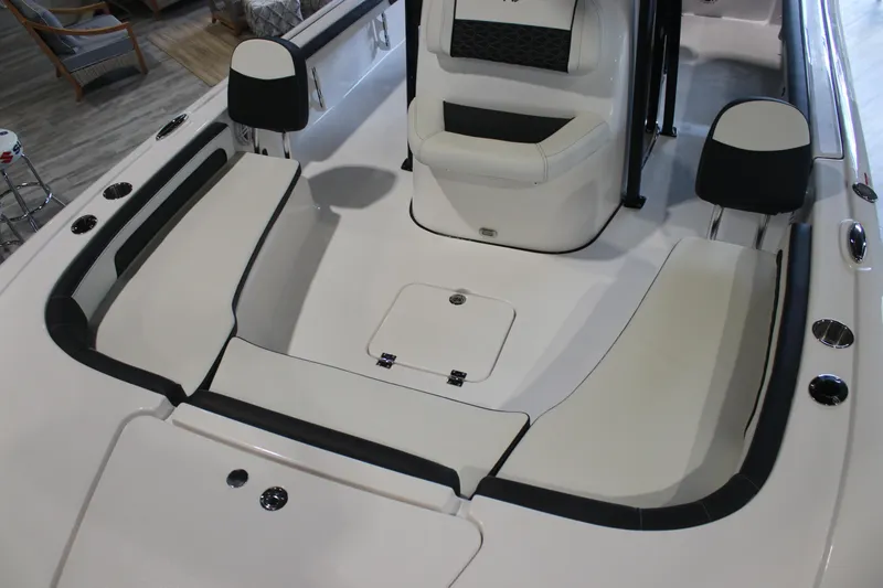 Slide: The Image of 2026 Tidewater 2300 Carolina Bay boat interior with cushioned seating and storage compartments. - 9