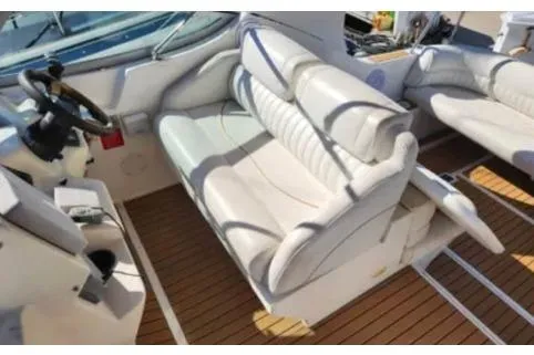 Slide: The Image of 1999 Cruisers Yachts 3375 Esprit interior with white seating and wooden flooring. - 3