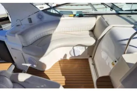 Slide: The Image of 1999 Cruisers Yachts 3375 Esprit interior with curved seating and wooden flooring. - 4