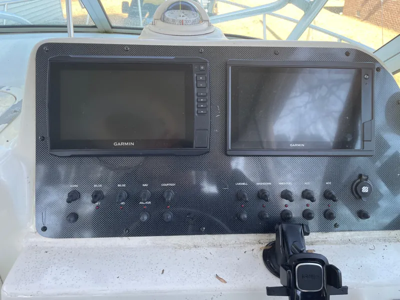 Slide: The Image of Control panel of a 2004 Hydra-Sports 230 WA boat with Garmin displays. - 4