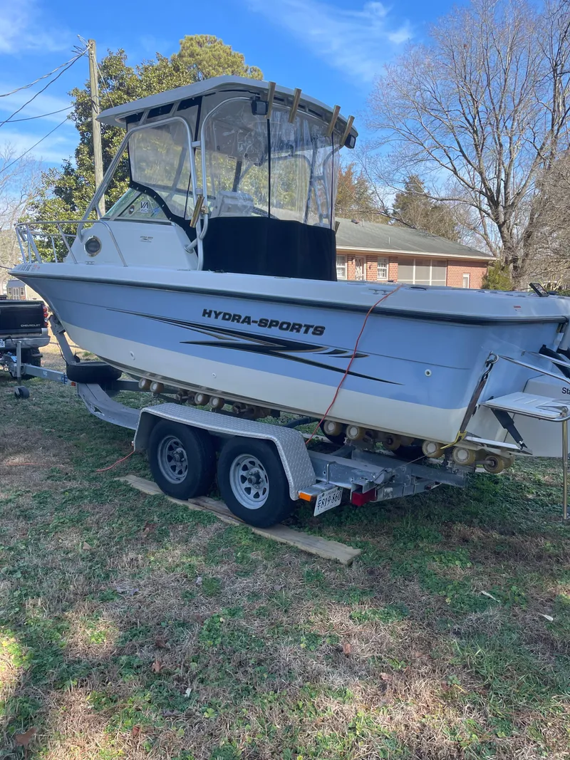 Slide: The Image of 2004 Hydra-Sports 230 WA boat on a trailer in a yard. - 9