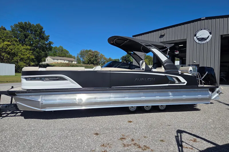 The Image of 2026 Avalon 2785 Excalibur LTD pontoon boat with quad lounger, parked outdoors. - 0