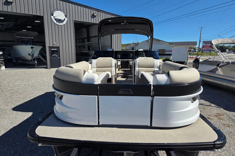Slide: The Image of 2026 Avalon 2785 Excalibur LTD pontoon boat with quad lounger, displayed outdoors. - 2