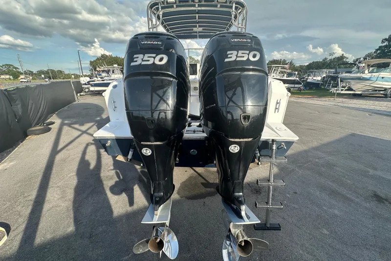 Slide: The Image of 2001 Contender 35 Side Console boat deck with rod holders and storage compartments. - 10