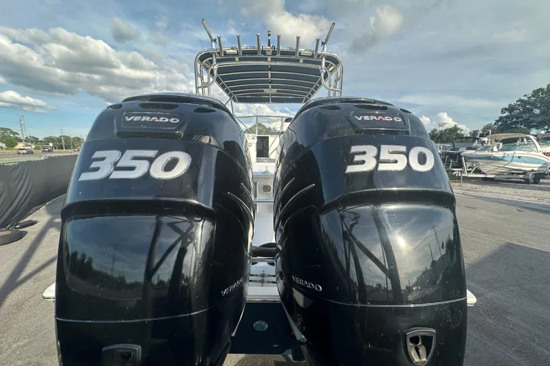 Slide: The Image of 2001 Contender 35 Side Console boat with spacious deck and canopy in a marina setting. - 11