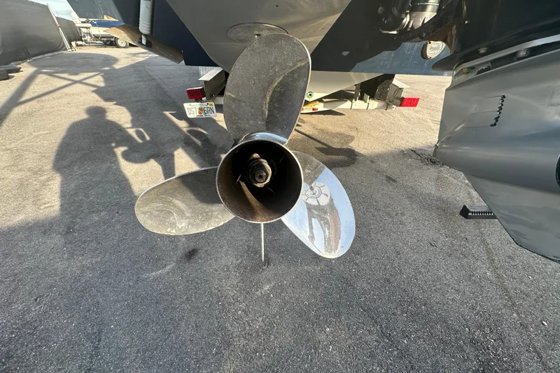 Slide: The Image of 2001 Contender 35 Side Console boat interior with sink, storage, and rod holders. - 13