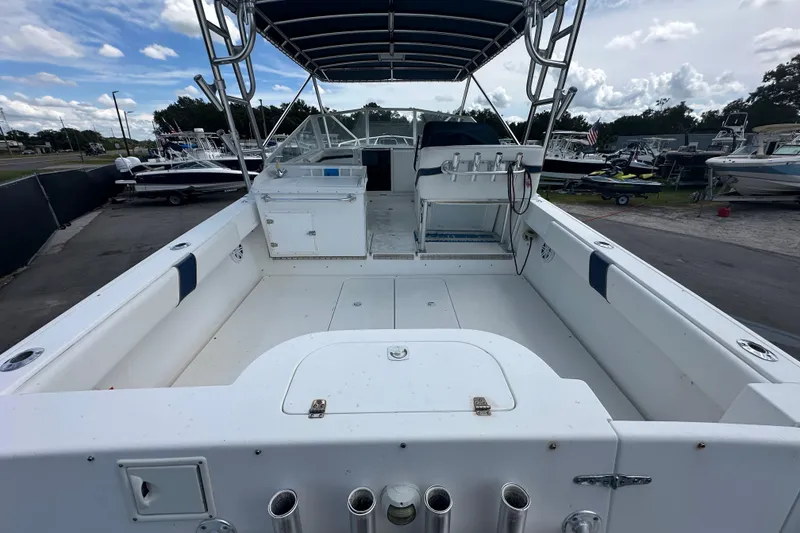 Slide: The Image of 2001 Contender 35 Side Console boat sink and storage area with cup holders. - 17
