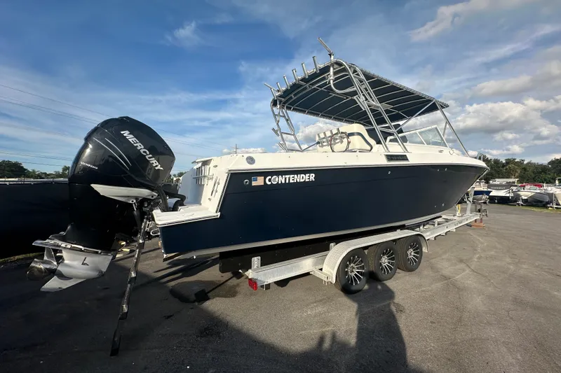 Slide: The Image of 2001 Contender 35 Side Console boat on trailer with Mercury outboard motor. - 2