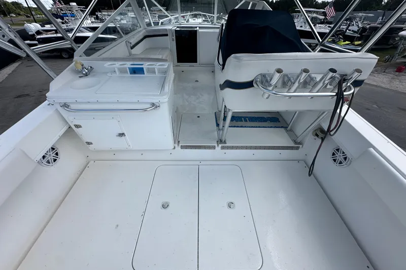 Slide: The Image of 2001 Contender 35 Side Console boat interior with steering wheel and rod holders. - 20
