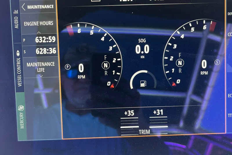 Slide: The Image of 2001 Contender 35 Side Console boat seating area with storage compartment. - 37