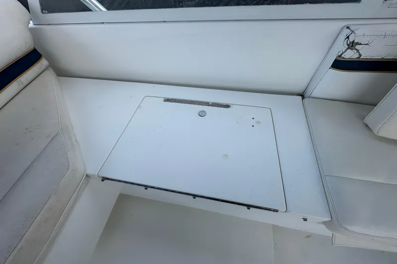 Slide: The Image of Open storage compartment on a 2001 Contender 35 Side Console boat, featuring speakers and equipment. - 43