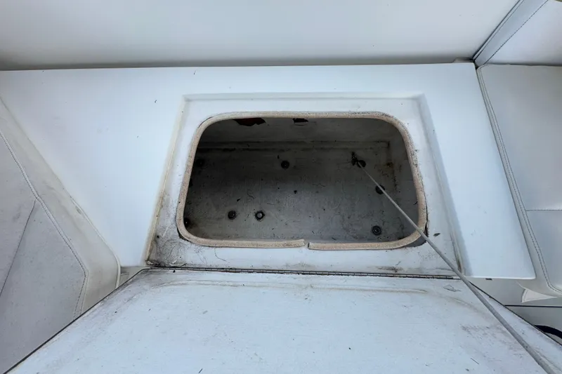 Slide: The Image of 2001 Contender 35 Side Console storage compartment with equipment and blue fenders. - 44