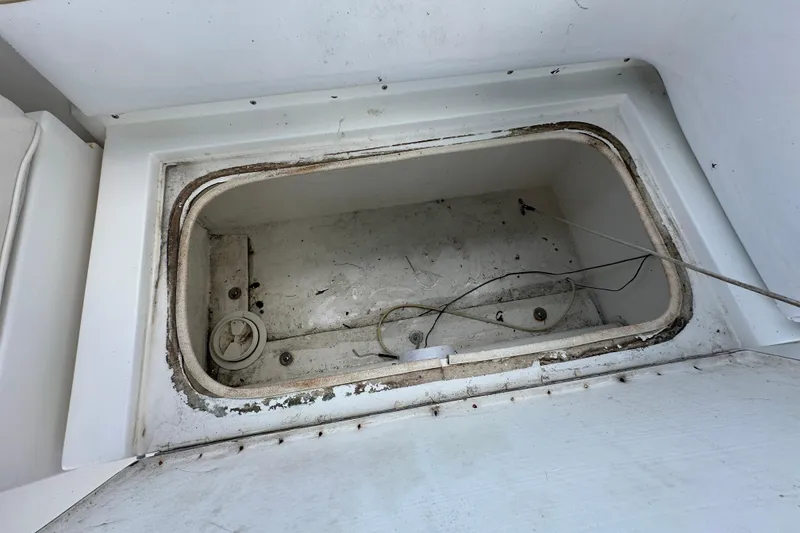 Slide: The Image of 2001 Contender 35 Side Console boat deck with railing and hatch, parked on a trailer. - 47