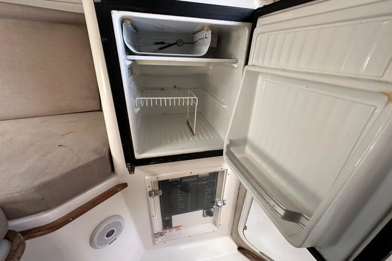 Slide: The Image of 2001 Contender 35 Side Console interior with wooden paneling and speaker. - 61