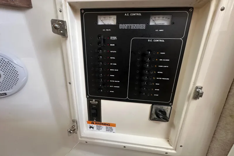 Slide: The Image of Open drawer in 2001 Contender 35 Side Console boat interior, featuring wood accents and speaker. - 62