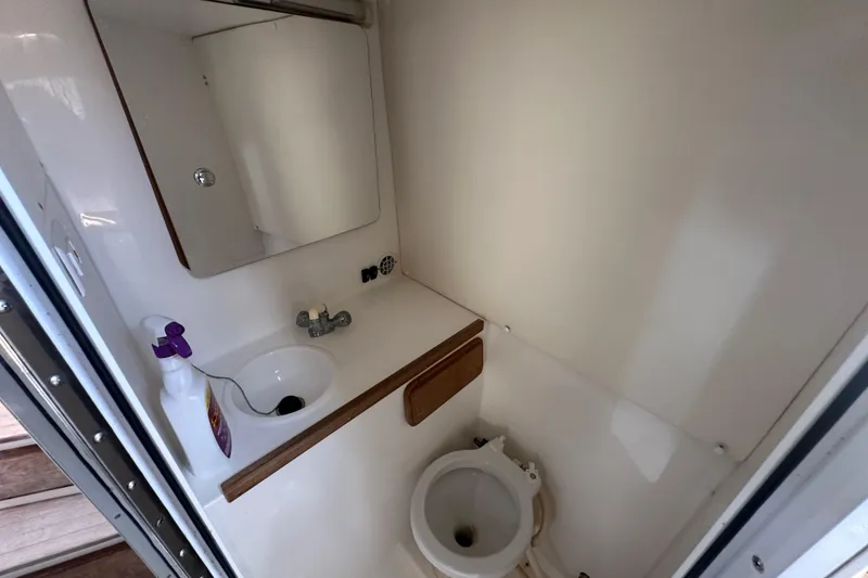 Slide: The Image of 2001 Contender 35 Side Console cabin interior with table and storage compartments. - 65