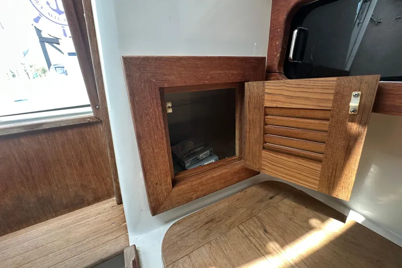 Slide: The Image of Open storage compartment on 2001 Contender 35 Side Console boat with red bag inside. - 68