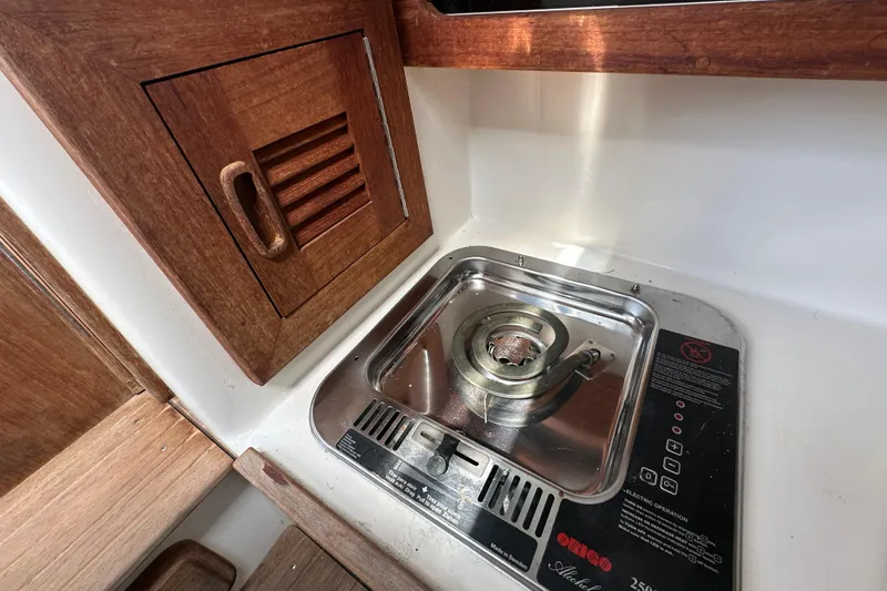 Slide: The Image of Storage compartment on 2001 Contender 35 Side Console with red life jacket inside. - 69