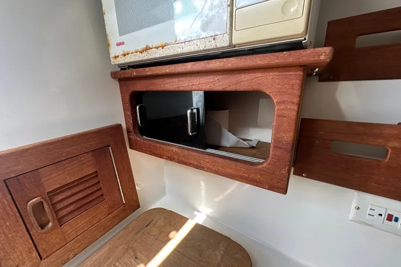 Slide: The Image of 2001 Contender 35 Side Console boat interior storage compartment. - 71
