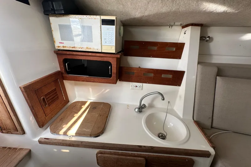 Slide: The Image of Open storage compartment on 2001 Contender 35 Side Console boat. - 73