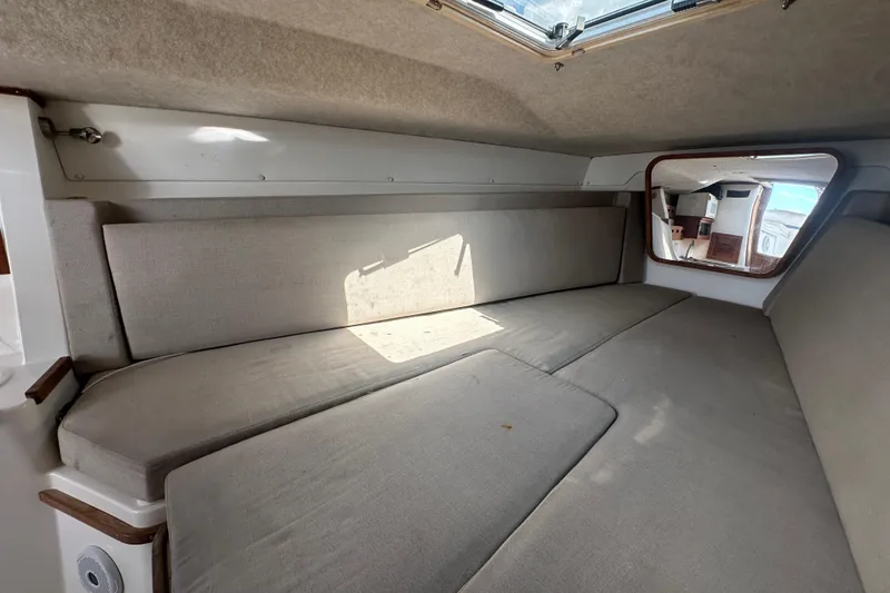 Slide: The Image of 2001 Contender 35 Side Console interior with cozy seating and wooden accents. - 74