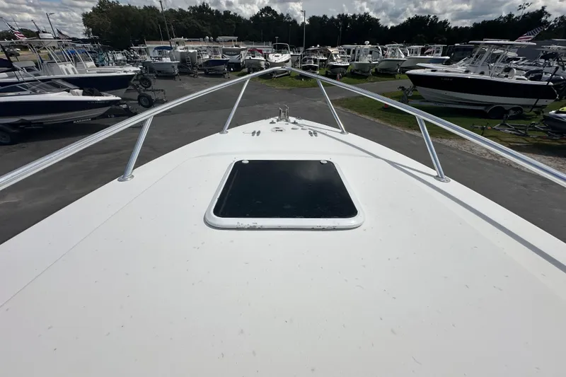 Slide: The Image of 2001 Contender 35 Side Console interior with wood accents and compact cabin space. - 79