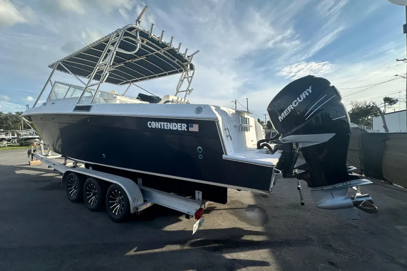 Slide: The Image of 2001 Contender 35 Side Console boat with spacious deck and fishing rod holders. - 8