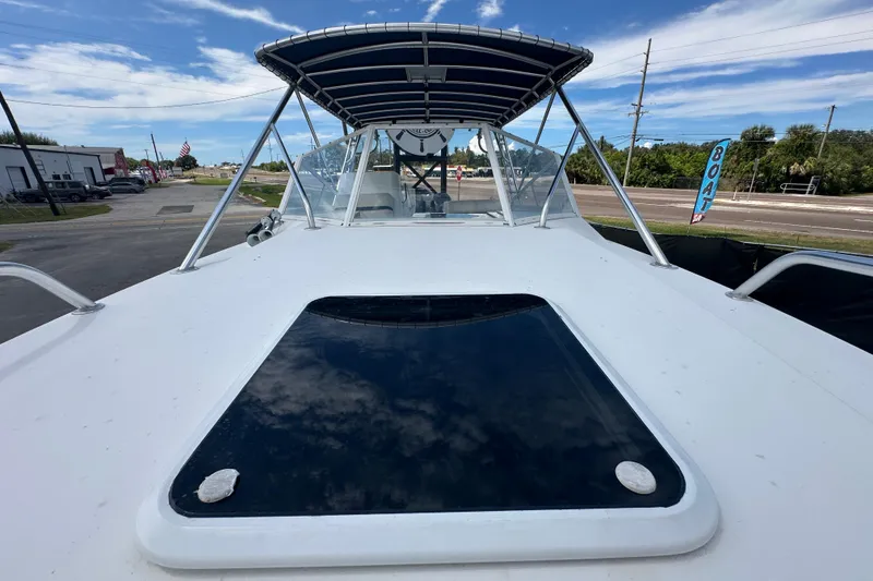 Slide: The Image of 2001 Contender 35 Side Console boat interior with white seating and open deck. - 84