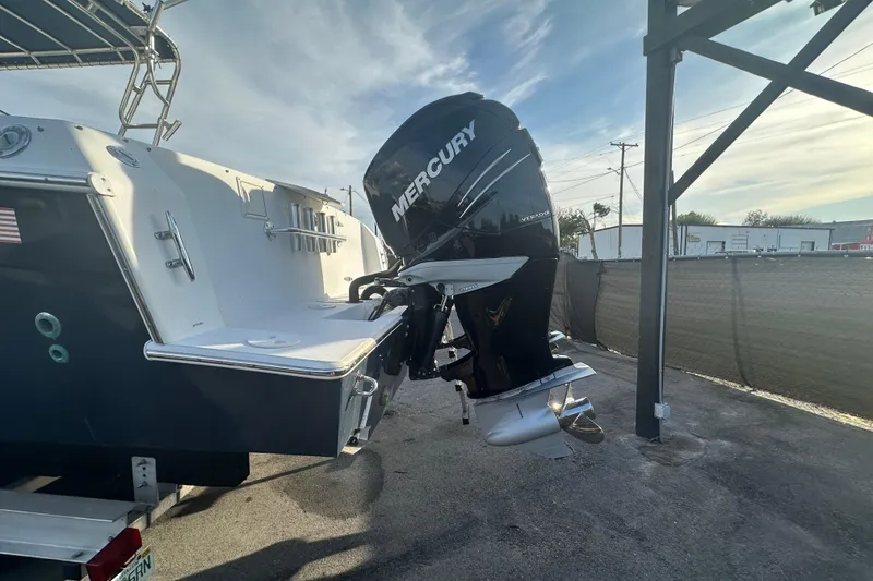 Slide: The Image of 2001 Contender 35 Side Console boat, spacious deck, rod holders, and helm station. - 9