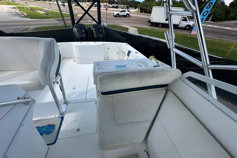 Slide: The Image of 2001 Contender 35 Side Console boat with open storage compartment and dual outboard motors. - 94