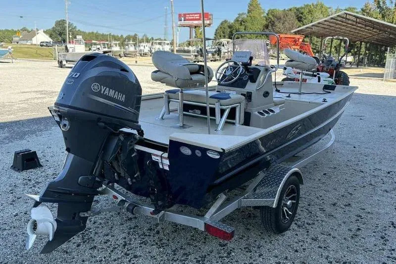Slide: The Image of 2021 G3 Bay 17 boat with Yamaha motor, parked on a trailer in a lot. - 1