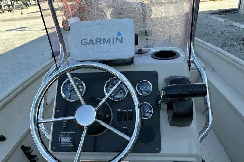 Slide: The Image of 2021 G3 Bay 17 boat dashboard with Garmin navigation system and steering wheel. - 2