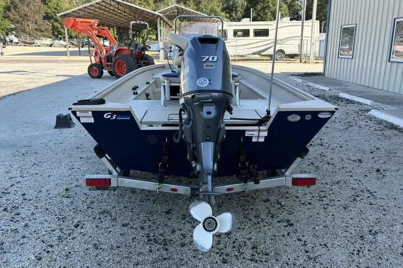 Slide: The Image of 2021 G3 Bay 17 boat with Yamaha 70 outboard motor, parked on gravel. - 3