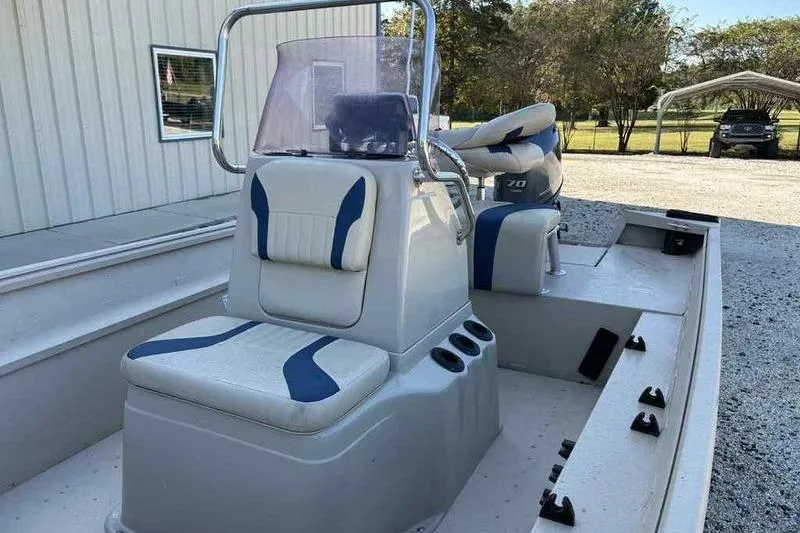 Slide: The Image of 2021 G3 Bay 17 boat interior with seating and console, parked outdoors. - 9