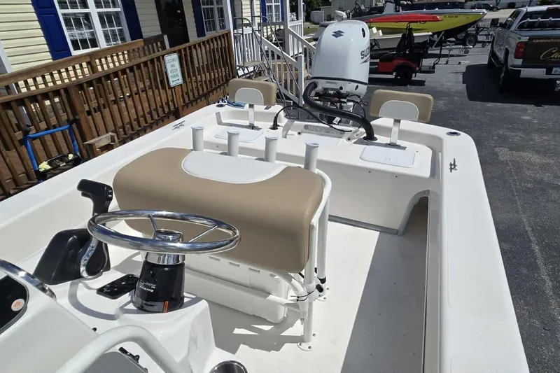 Slide: The Image of 2026 Sundance B22CCR boat with beige seating and Suzuki outboard motor. - 12