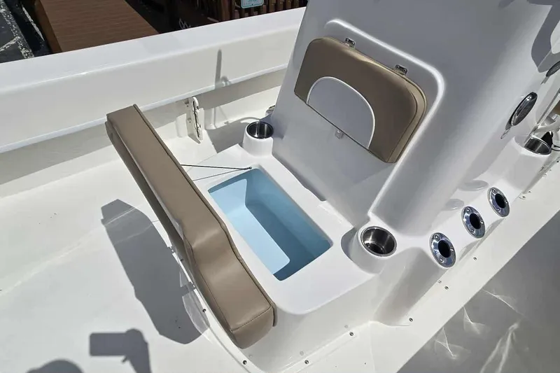 Slide: The Image of 2026 Sundance B22CCR boat interior with cushioned seating and built-in storage compartments. - 13