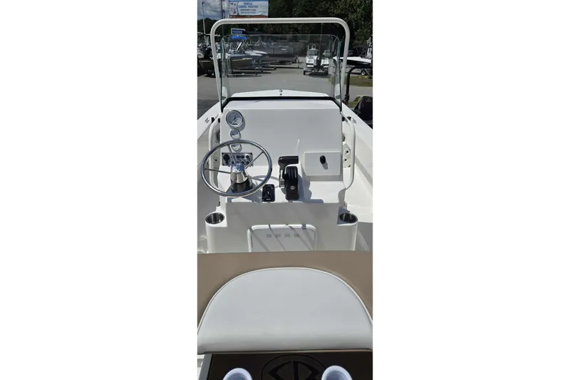 Slide: The Image of 2026 Sundance B22CCR boat console with steering wheel and controls. - 16