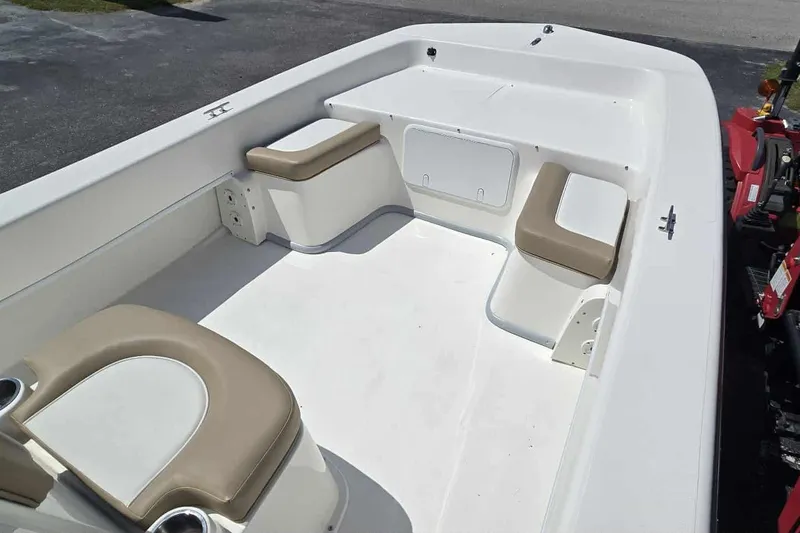 Slide: The Image of 2026 Sundance B22CCR boat interior with beige seating and spacious layout. - 8