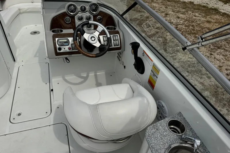 Slide: The Image of 2007 Formula 240 Bowrider cockpit with steering wheel, gauges, and white captain's chair. - 13