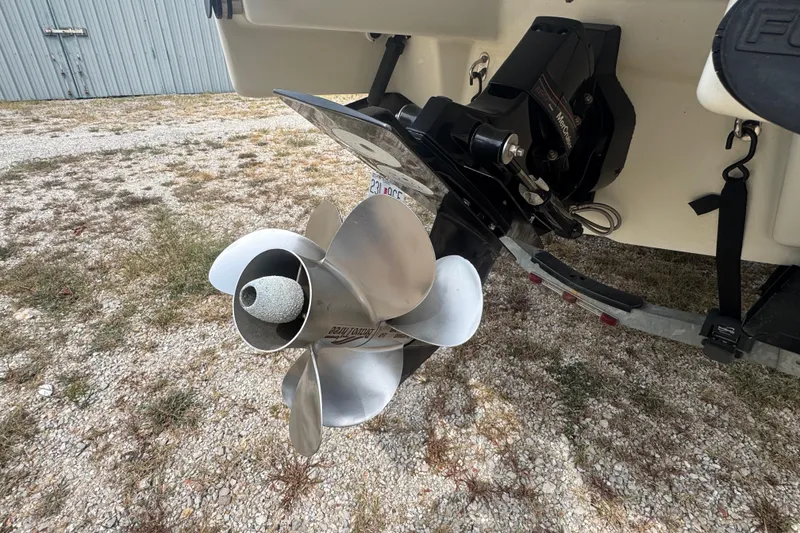 Slide: The Image of 2007 Formula 240 Bowrider boat propeller and stern drive on gravel surface. - 19