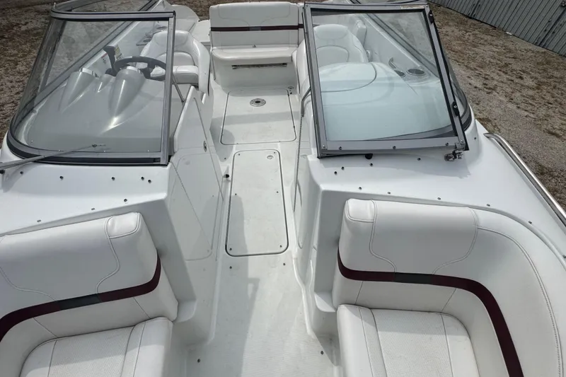 Slide: The Image of 2007 Formula 240 Bowrider boat interior with white seating and dual windshields. - 6
