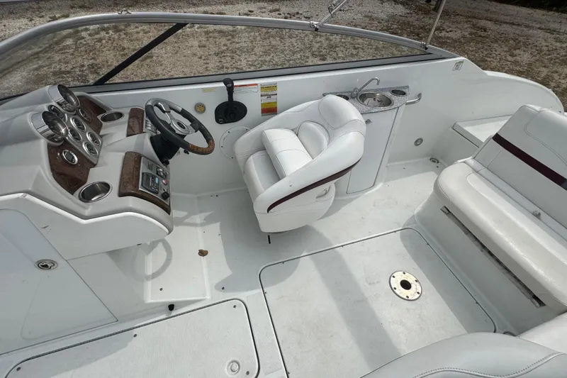 Slide: The Image of 2007 Formula 240 Bowrider interior with white seating, steering wheel, and dashboard controls. - 7
