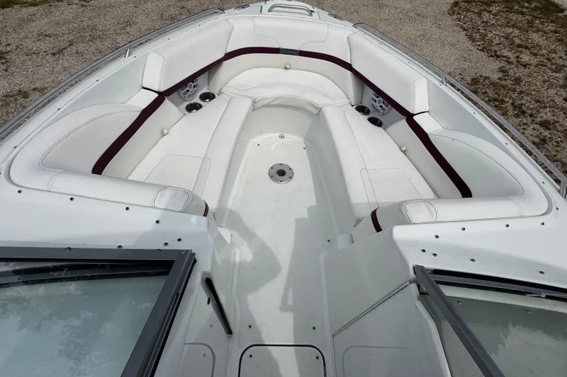 Slide: The Image of 2007 Formula 240 Bowrider boat interior with white seating and maroon accents. - 8
