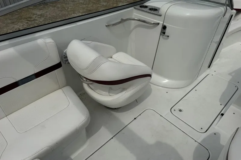 Slide: The Image of 2007 Formula 240 Bowrider interior with white seating and cup holders. - 9