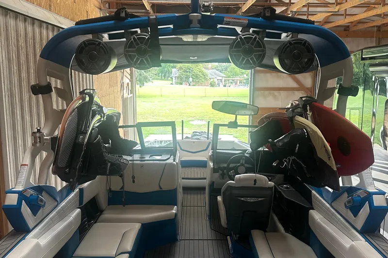 Slide: The Image of 2021 Nautique Super Air Nautique G25 interior with wakeboards and speakers. - 2